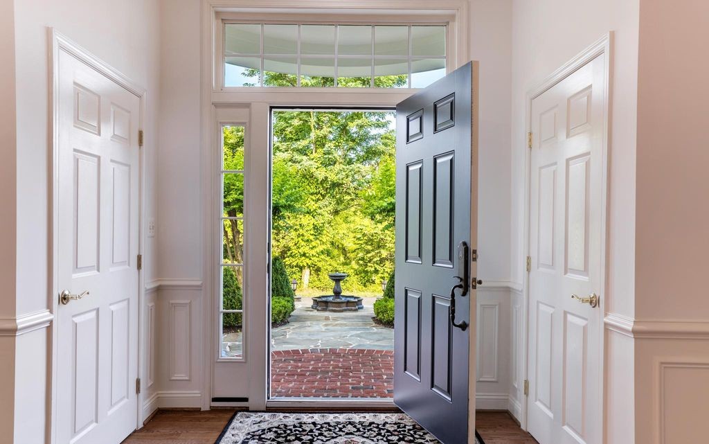 Front entry hall with view to a stone fountain courtyard