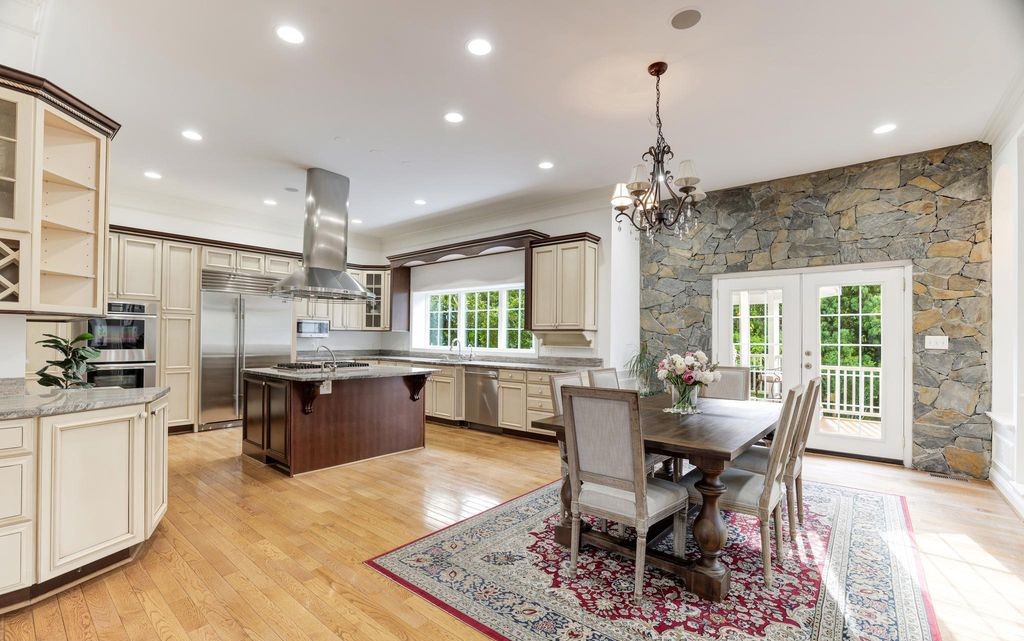 Chef's kitchen with stone accent wall, representative of homes Eileen shows buyers